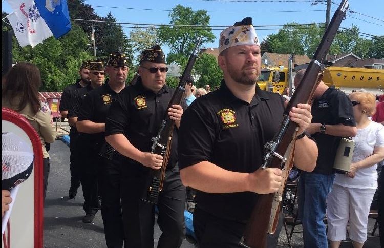 Local veterans marching with rifles