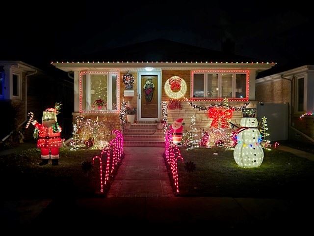 House with lighted candy canes, Santa and snowman