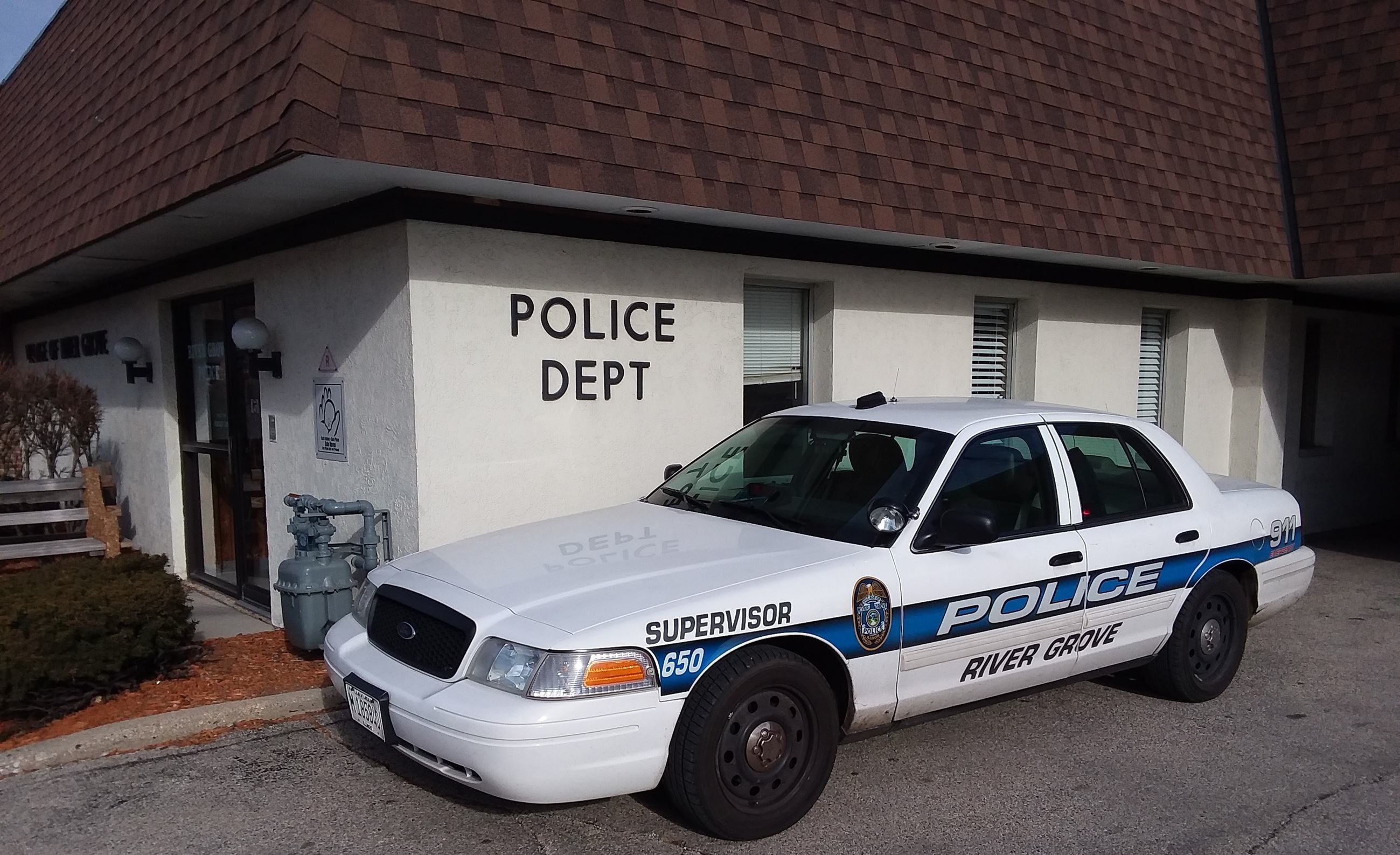 Police Department with the Supervisor’s squad car parked in front